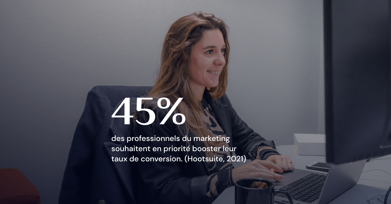 Une jeune femme souriante suit les statistiques pour mesurer ses actions marketing